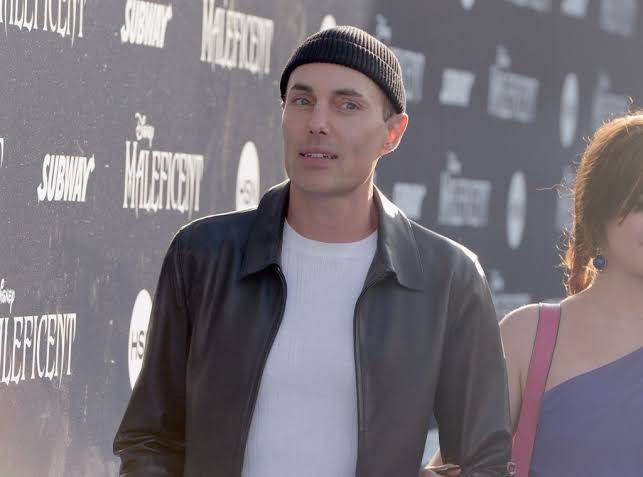 James Haven in a black beanie and leather jacket at a "Maleficent" event.