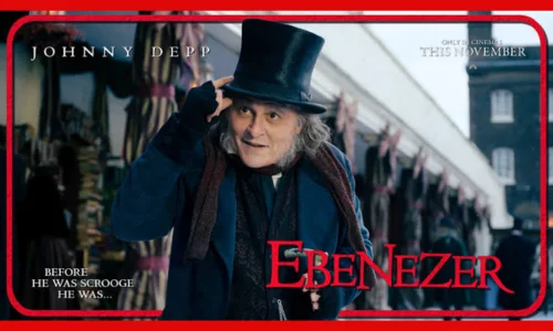 Johnny Depp dressed as Ebenezer Scrooge wearing a tall black hat on a snowy street