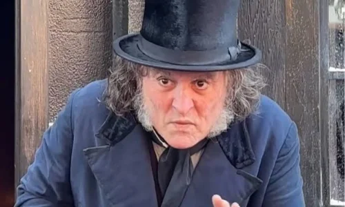 Close-up of Johnny Depp wearing Scrooge costume and a black top hat