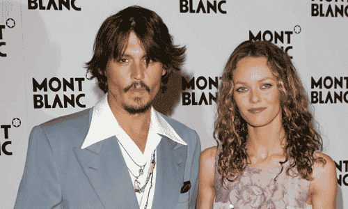 Johnny Depp and Vanessa Paradis posing together at a public event