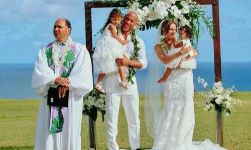 Dwayne Johnson and Lauren Hashian standing together at their beachside Hawaii wedding