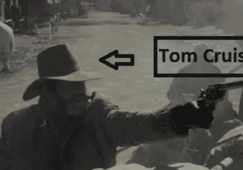 Tom Cruise wearing a cowboy hat and mustache during his uncredited Young Guns cameo