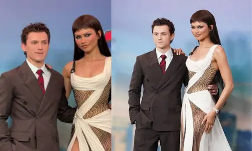 Actors Zendaya and Tom Holland standing close together at a red carpet event. 