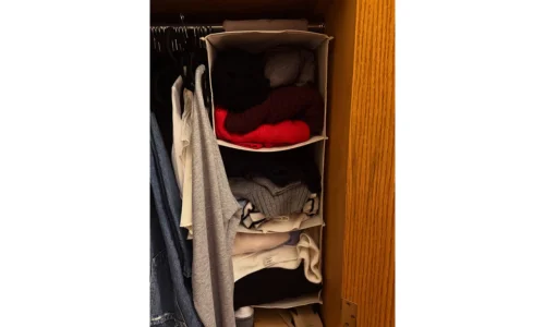 Organized college dorm storage setup with shelves and room essentials