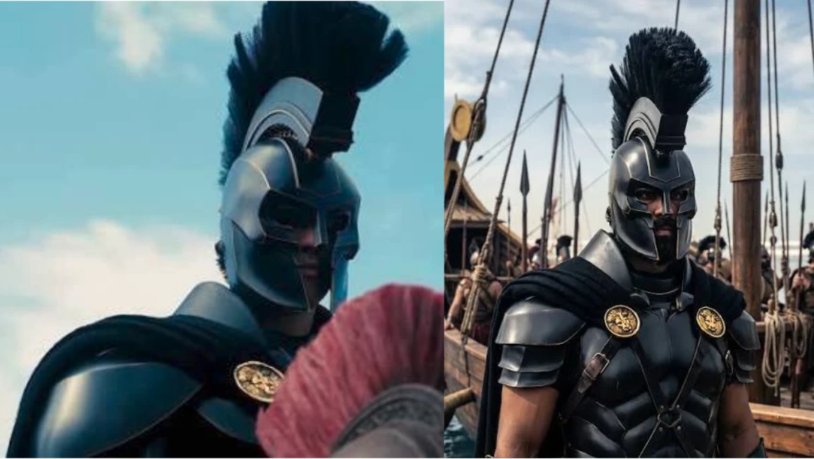 Warrior wearing black armor and a tall crested helmet standing beside a ship with soldiers in the background.