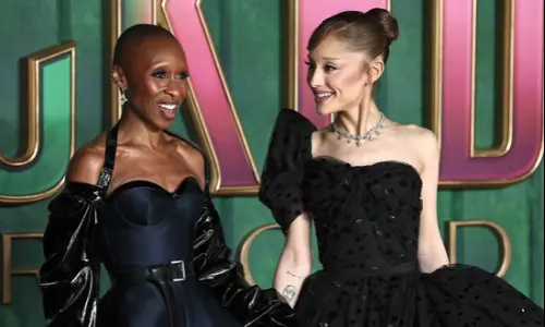 Ariana Grande and Cynthia Erivo standing together on the red carpet at a Wicked premiere