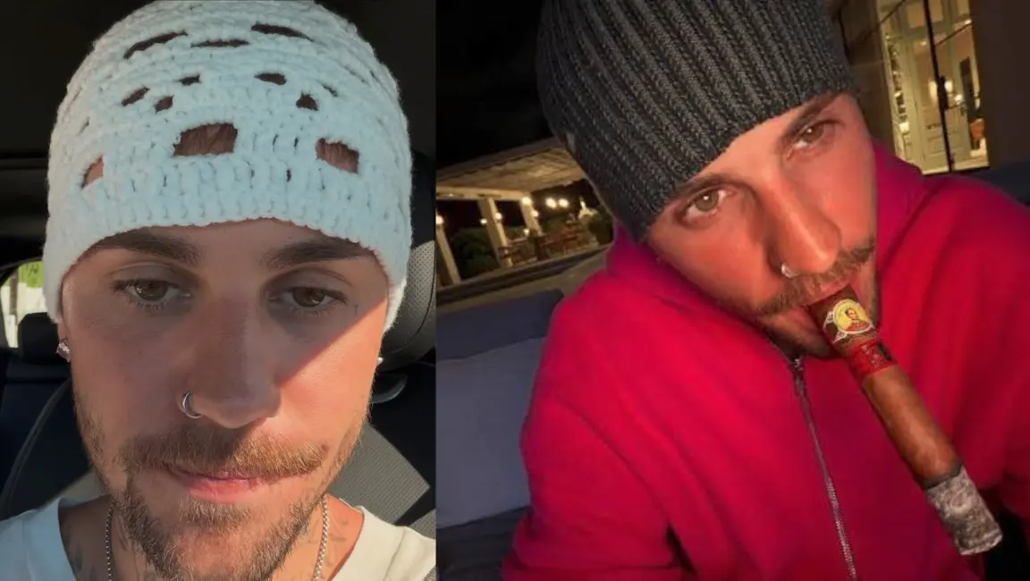 A Justin bieber looking into the camera while wearing a white, chunky crochet knit beanie with open stitch cutouts.