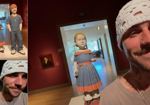 Justin Bieber in a white crochet beanie poses for selfies near artwork on a SKYLRK gallery trip.