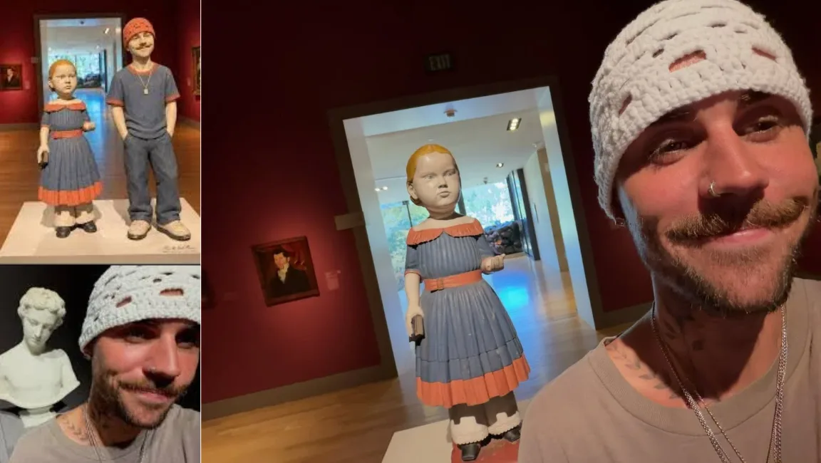 Justin Bieber in a white crochet beanie poses for selfies near artwork on a SKYLRK gallery trip.