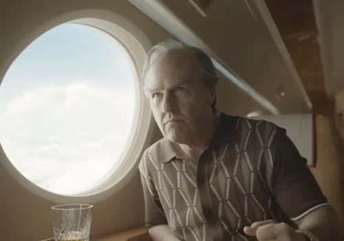 A close-up of a heavily aged Tom Cruise as Ethan Hunt sitting inside a private jet.