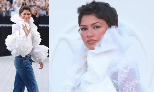 Zendaya wearing a dramatic white lace top with blue jeans at The Odyssey premiere.
